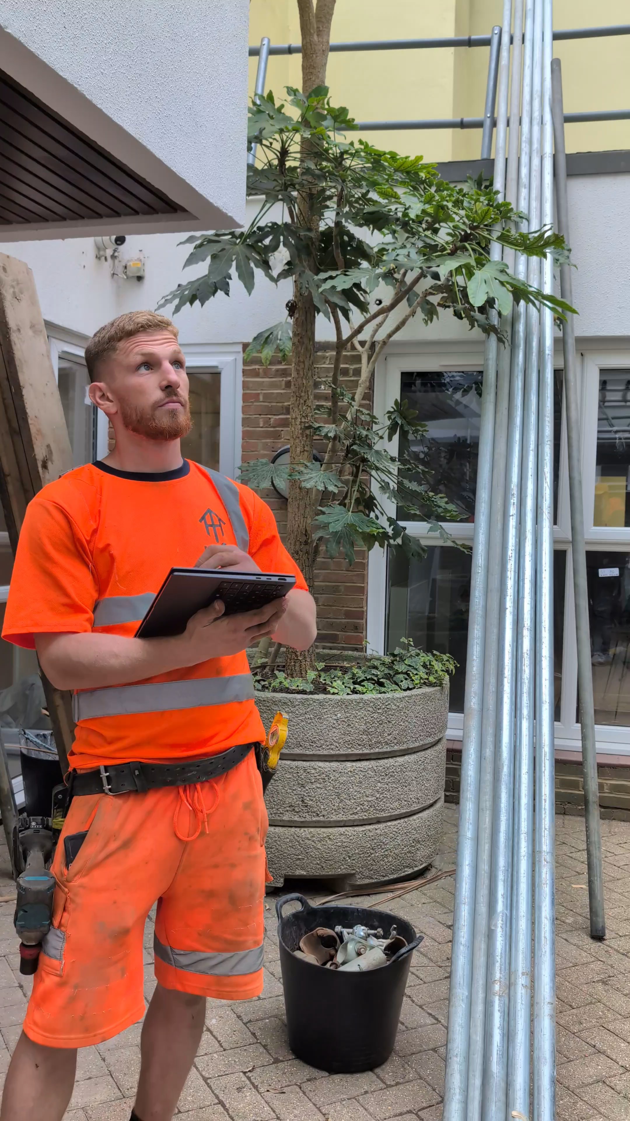 HTK scaffolder surveying a job on site with a tablet